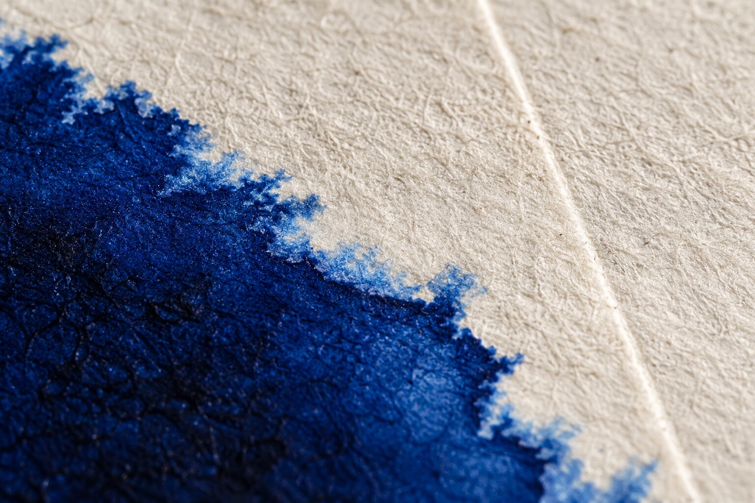 Macro detail of cobalt ink on cotton paper